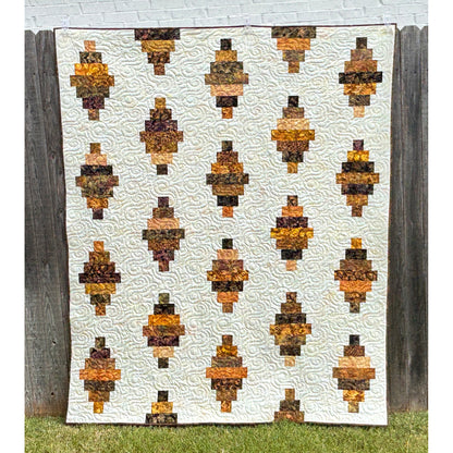 Floating Lanterns quilt shows off those fabric strips! - in this picture they are in shades of brown with a cream background fabric.