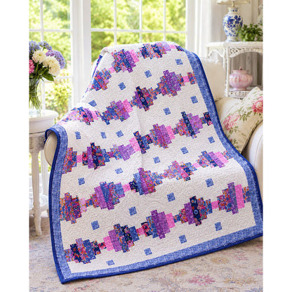 Good Vibrations is a beginner-friendly quilt that turns pre-cut fabric strips into a bold design full of movement and color. Almost like colorful beads across the quilt.