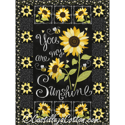 Decorative quilt with sunflower design and text 'You are my sunshine' on a black background.