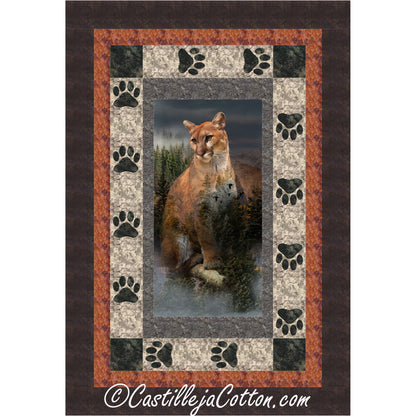 Quilt with a cougar design in the center, surrounded by paw prints and a brown border.