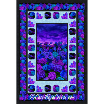 A vibrant purple and blue floral quilt elegantly displayed within a sleek black frame, showcasing intricate patterns.