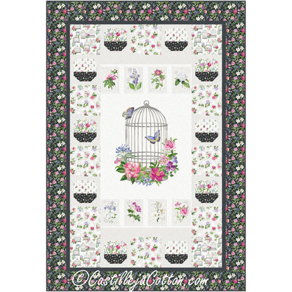 Pretty floral quilt features a print with a birdcage with flowers around the base and two butterflies. There are individual flowers at the top and bottom and then bordered with floral print with white background and then a dense carpet of flowers print.