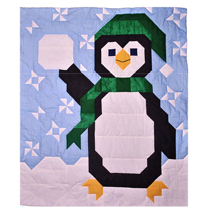 Penguin quilt features a large penguin with snow and wearing a hat and scarf. In his one hand, he is holding a snowball.