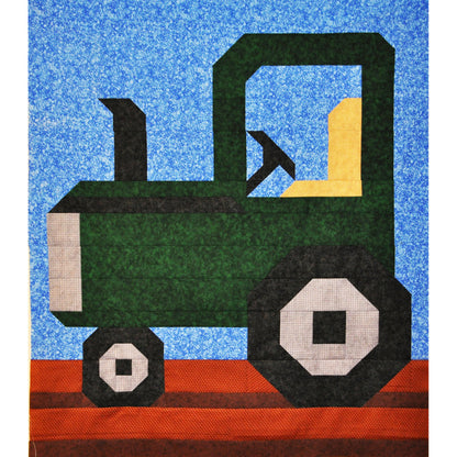 Quilt block of a green tractor on a blue background