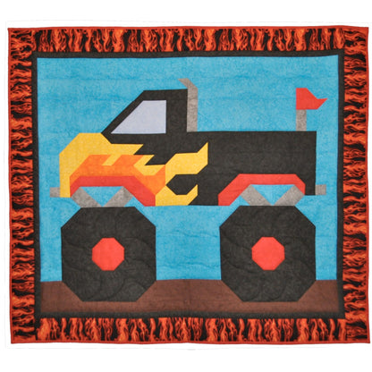 Children's quilt with a colorful monster truck design on a blue background