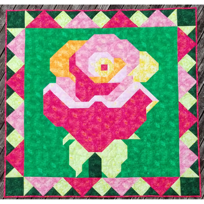 Quilt with a colorful rose design on a green background