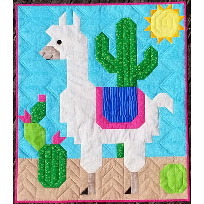 Quilt with llama and cactus design on a blue background