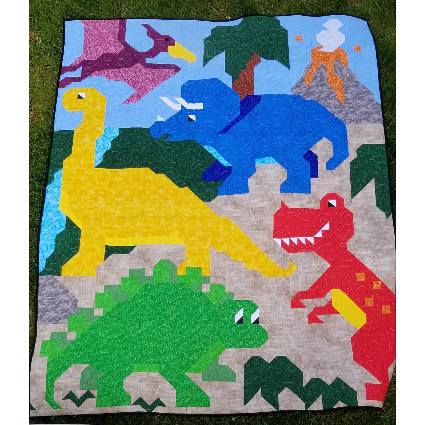 This quilt features 5 dinosaur friends in a collage style image. 