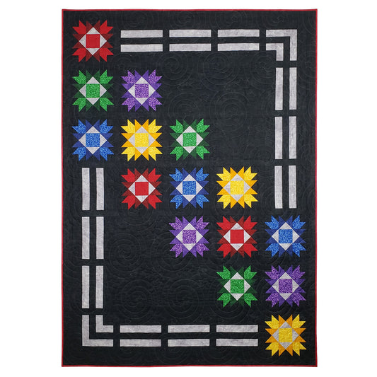 Fun quilt features a row of double lines, like a trail, along the top to right cover and partway down. There are bright stars through the middle at an angle from top left to bottom right. Bottom and left side the trail continues.