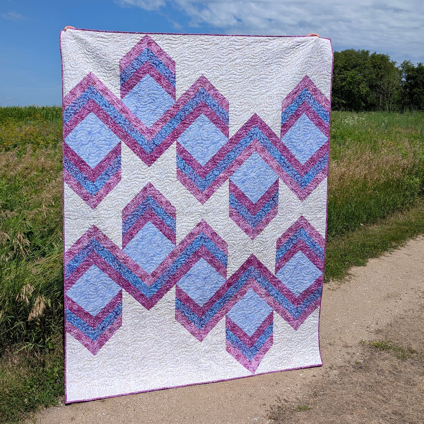 Quilt features ribbons of chevrons to give it a 3-demensional look.