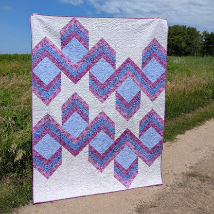 Quilt features ribbons of chevrons to give it a 3-demensional look.