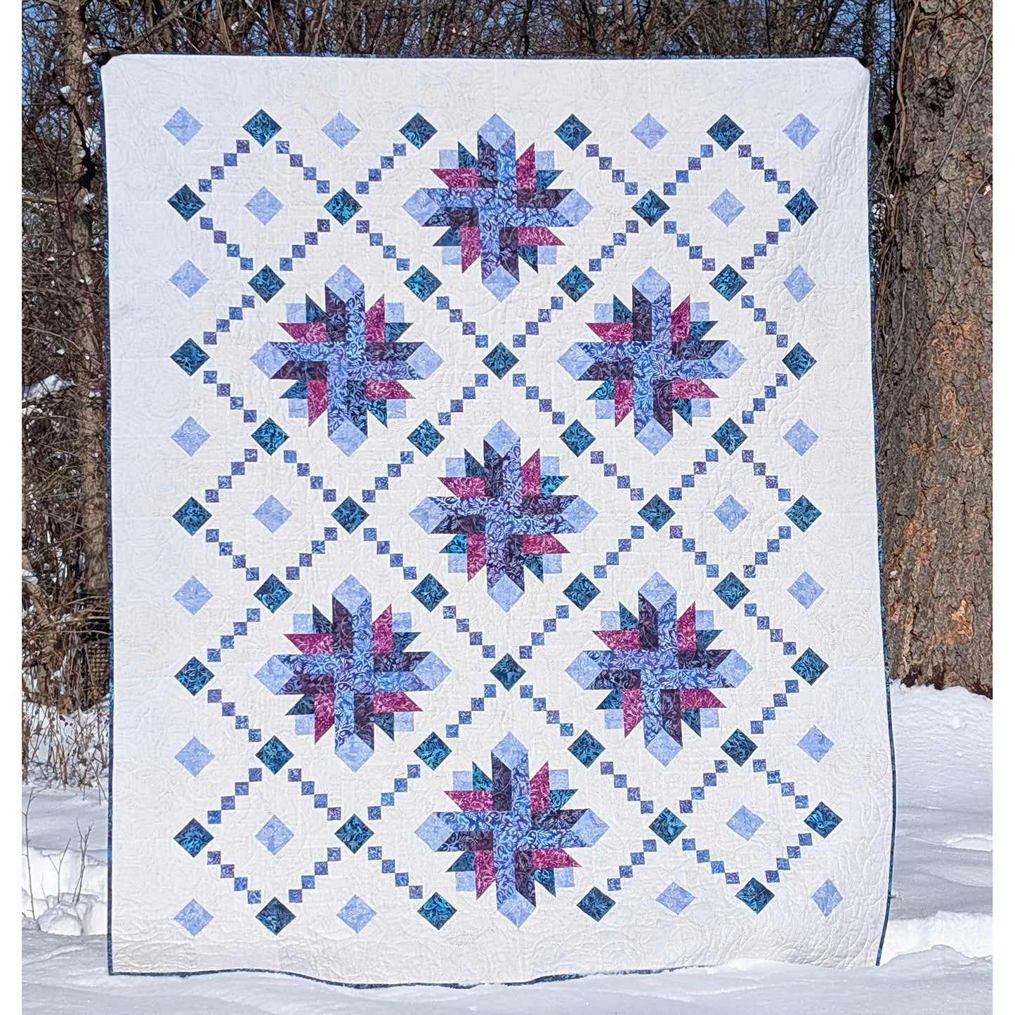 Shining Lace quilt features delicate strip-pieced chains surround elegant starburst blooms. 