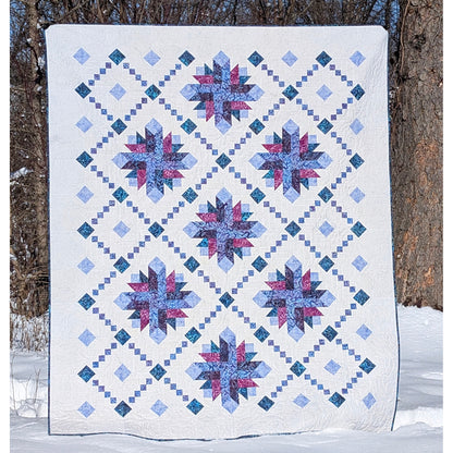 Shining Lace quilt features delicate strip-pieced chains surround elegant starburst blooms. 