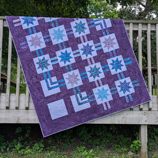 Pretty quilt features blocks of stars and lines between blocks as if it's a flow chart.