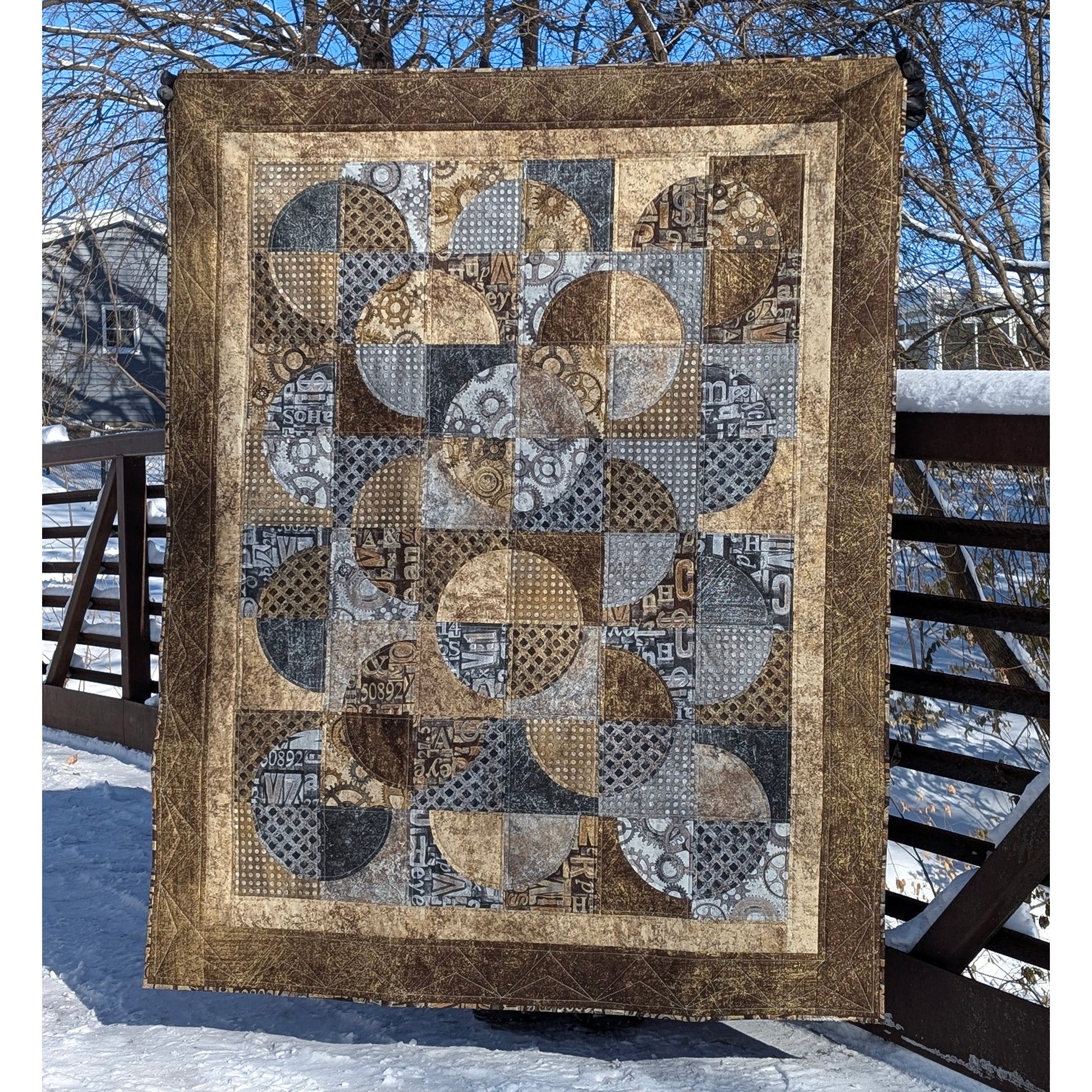 Quilt features neutral colors of fabric with overlapping circles broken into 4 fabrics.