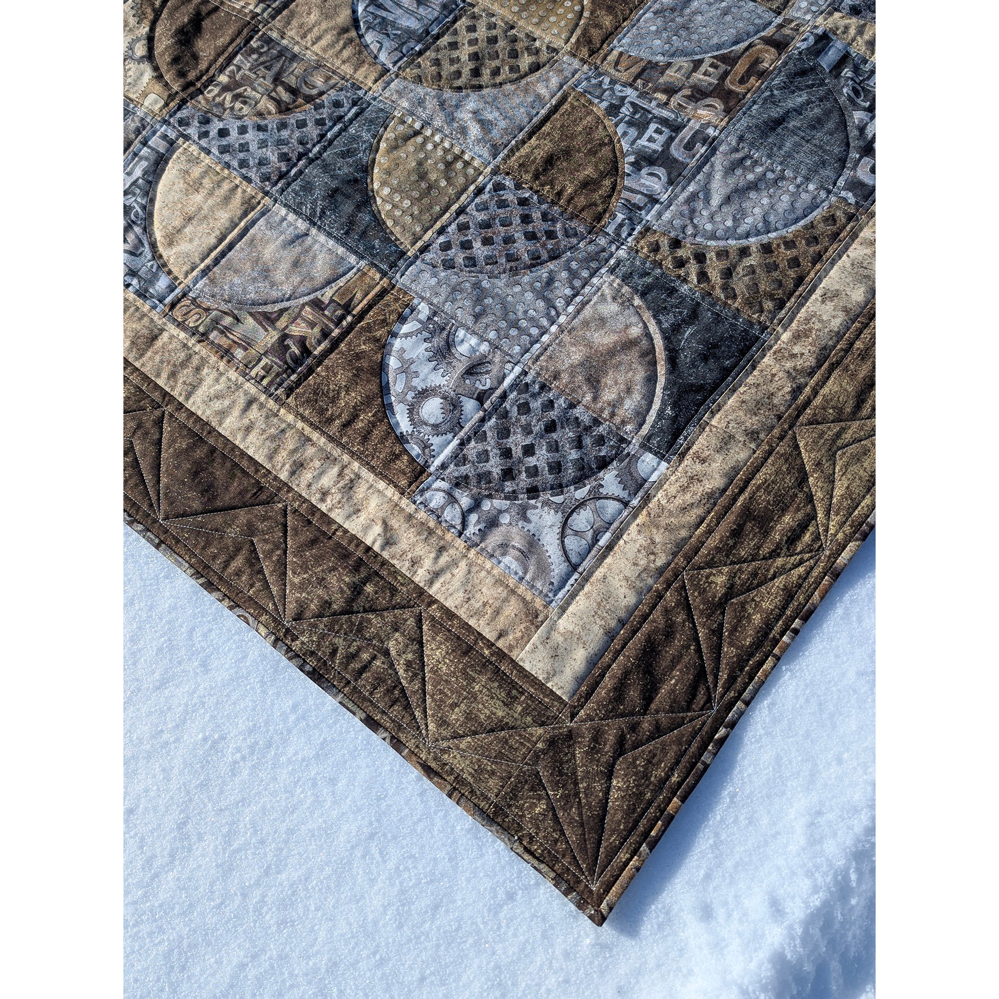 Close up of Quilt features neutral colors of fabric with overlapping circles broken into 4 fabrics.