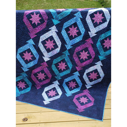 Quilt features long triangular "ornaments" or "party crackers" with ohio stars in each. Fun festive quilt.