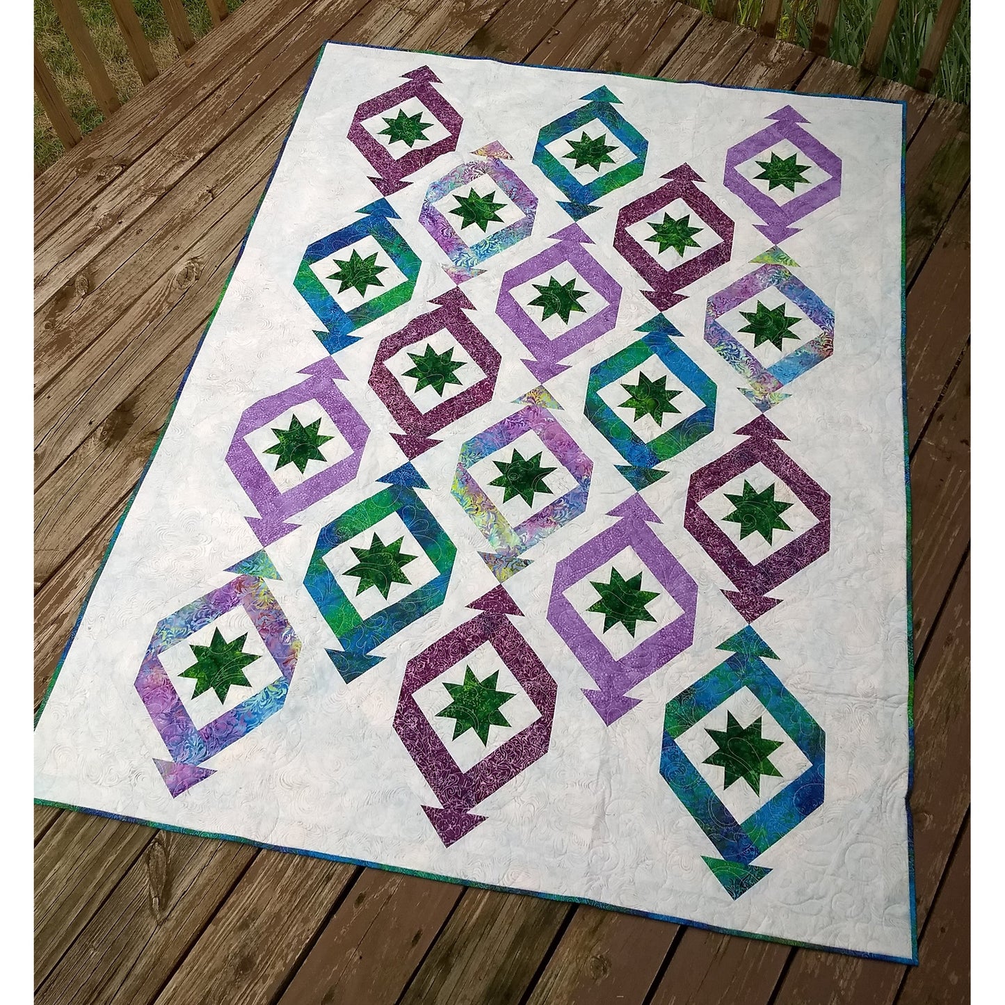 Quilt features long triangular "ornaments" or "party crackers" with ohio stars in each. Fun festive quilt.