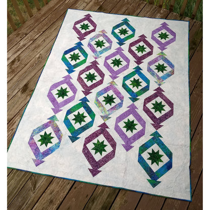 Quilt features long triangular "ornaments" or "party crackers" with ohio stars in each. Fun festive quilt.