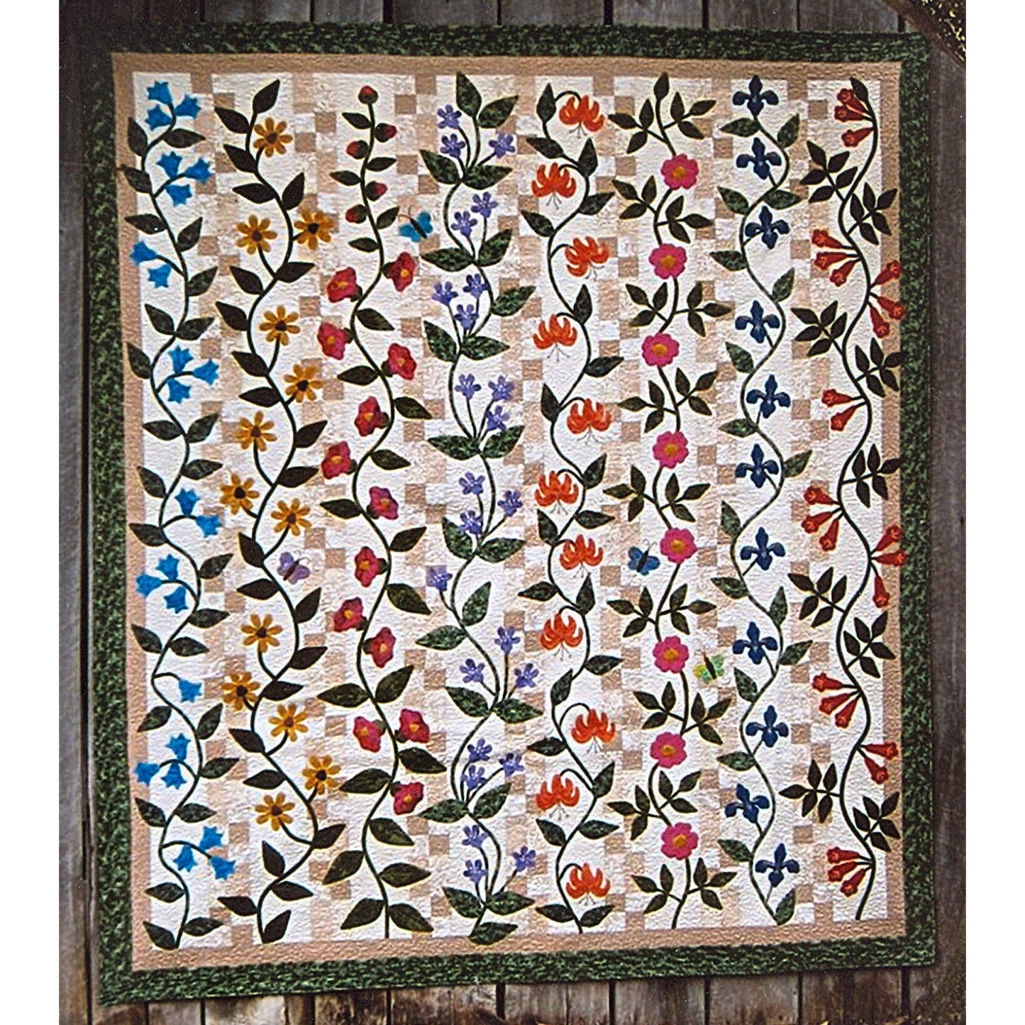 Beautiful quilt features rows of different flowers in their vines on top of a checker row in light tan. 