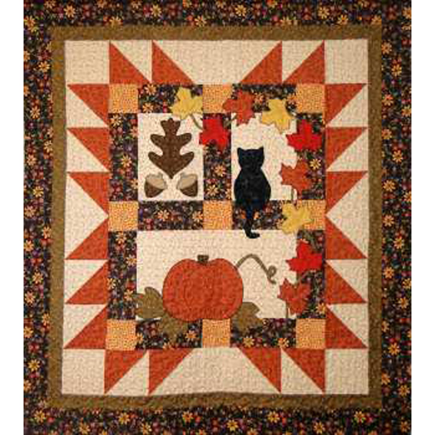 Lovely fall quilt features blocks of leaf and acorns, black cat sitting in a window, pumpkin and fall-colored maple leaves with fun border.