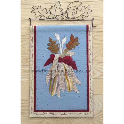 Beautiful mini wall hanging features corn with a couple of leaves bundled together.