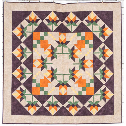 Beautiful quilt features orange flowers in the middle, with a fun pattern for the leaves and in squares around the outside.  Fun for any season.