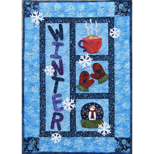 Quilt with winter-themed design featuring a cup, mittens, snowman, and text on a blue background.