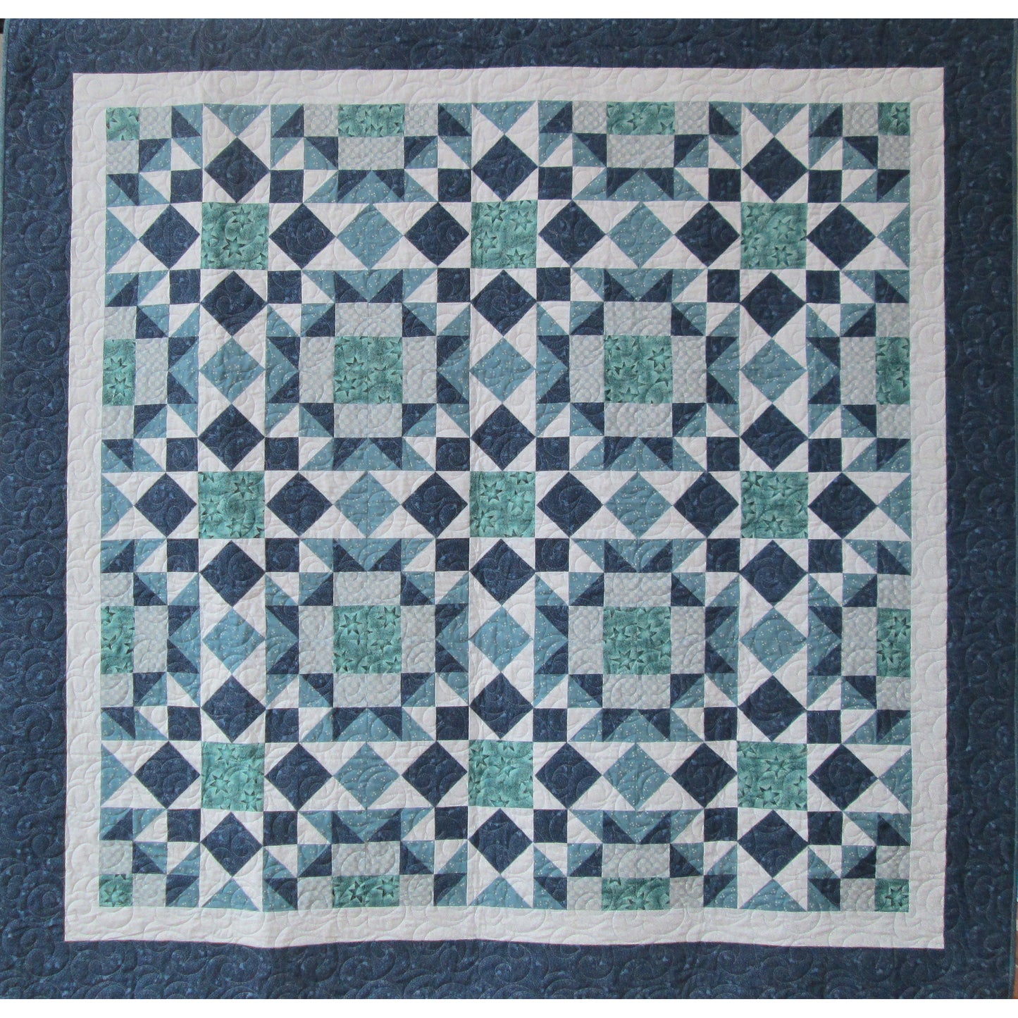Fun stars, squares and diamonds quilt in blues and greens.