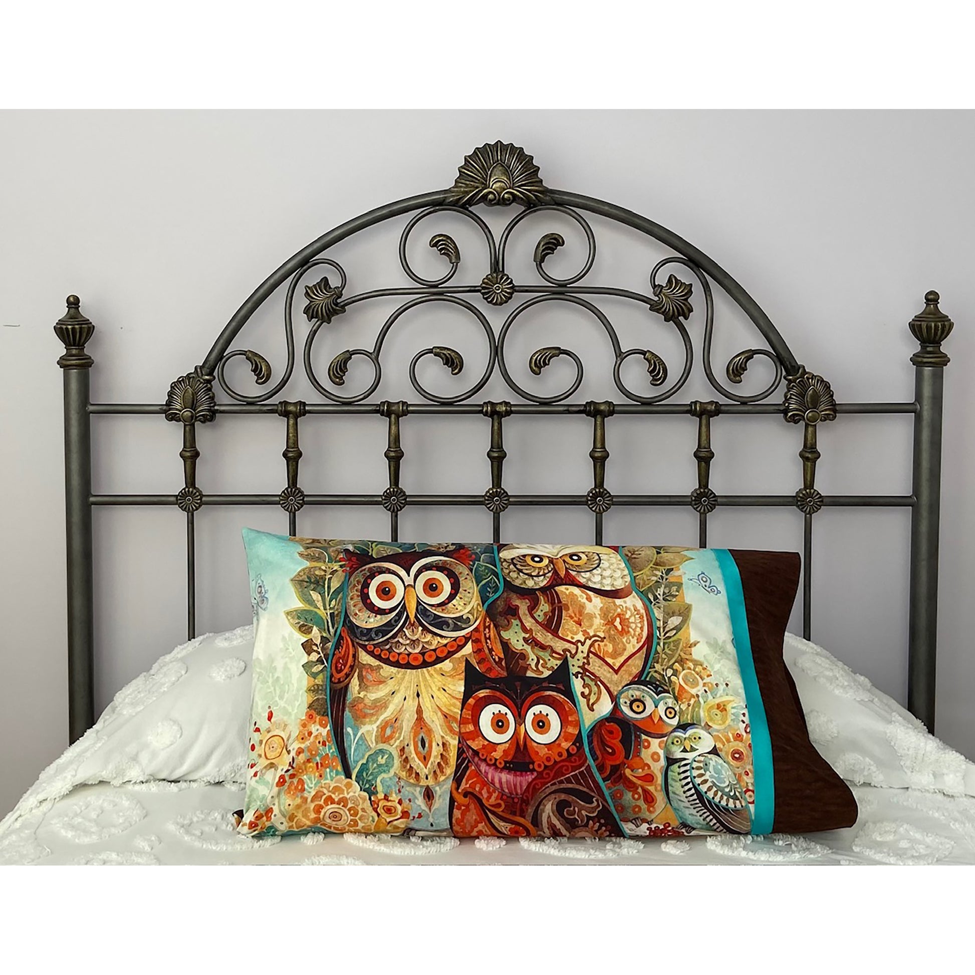 Pillow on a bed with pillowcase showcasing a beautiful owls fabric.