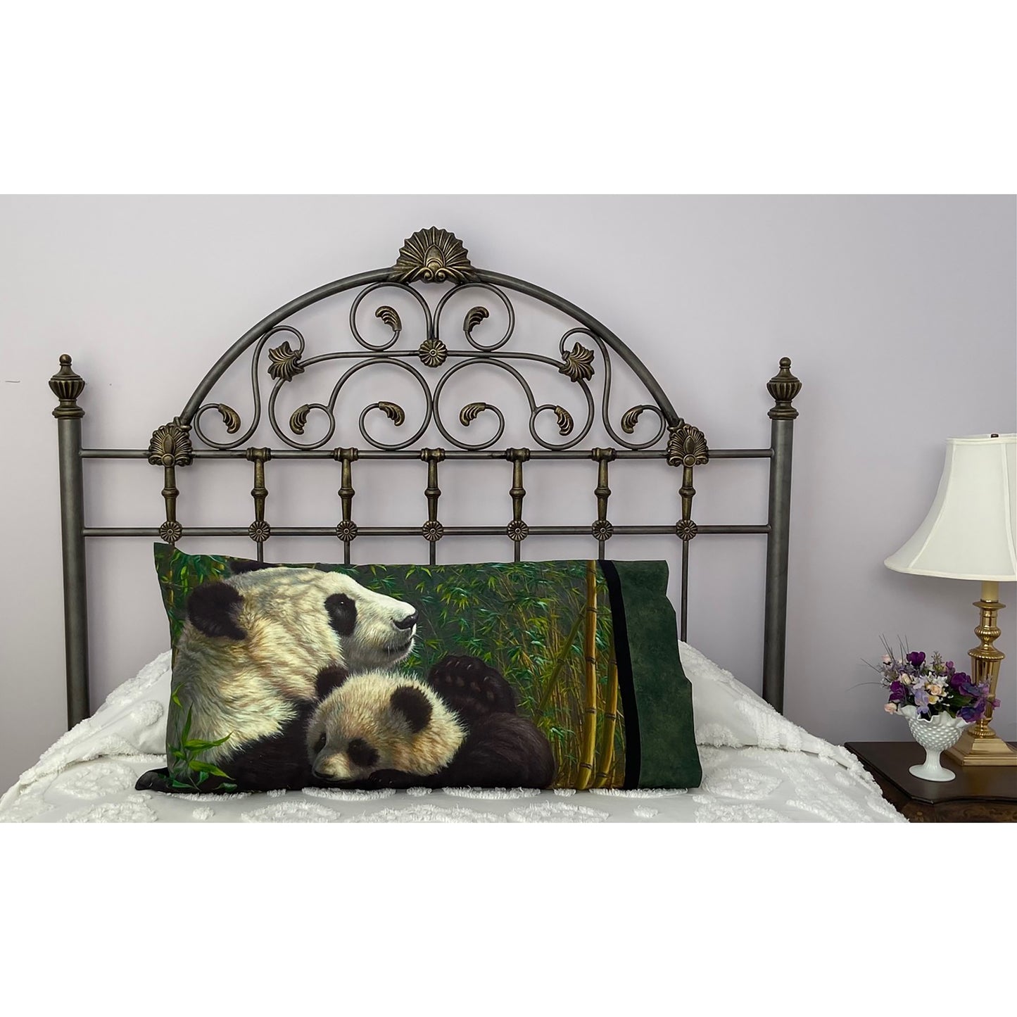 Pillow on a bed with pillowcase showcasing a loveable pandas fabric.