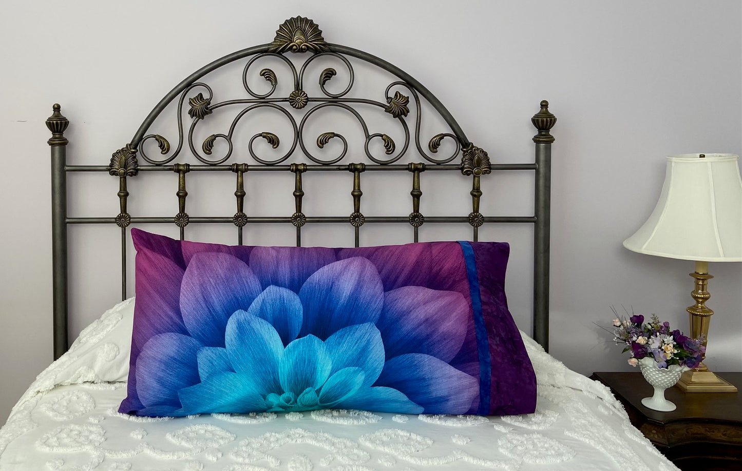 Pillow on a bed with pillowcase showcasing a beautiful flower fabric.