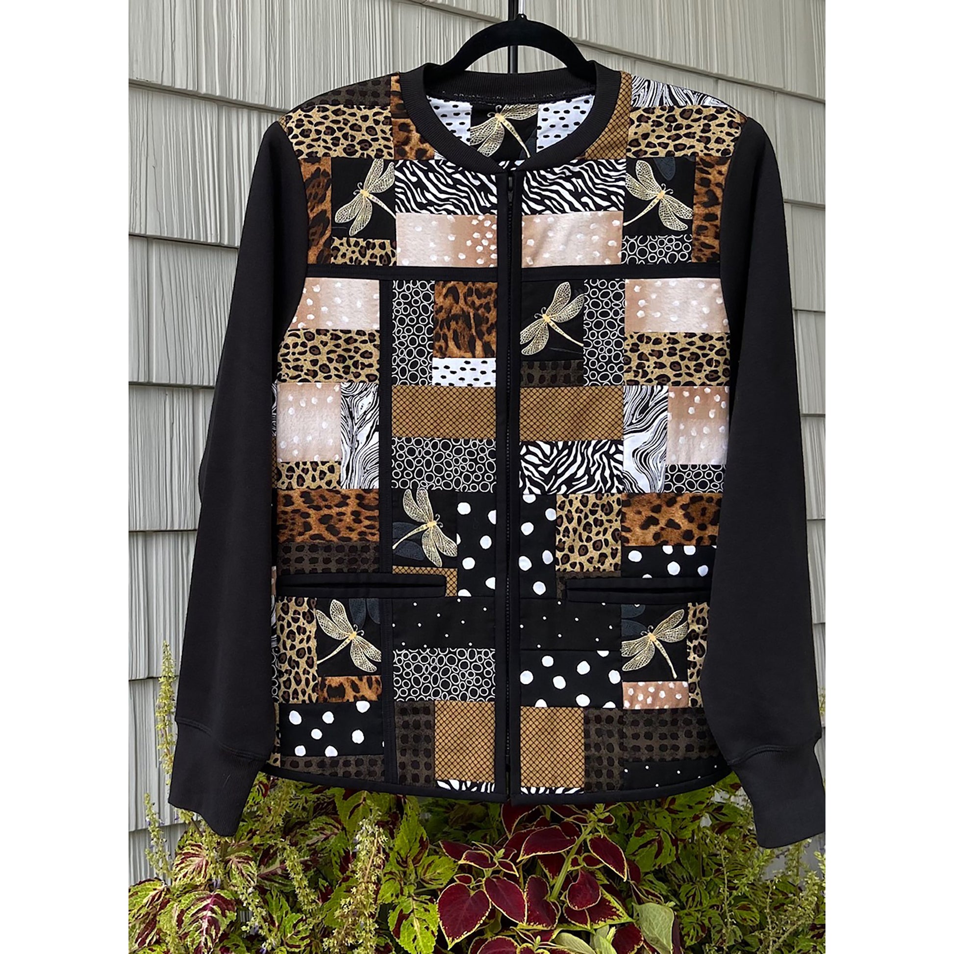 Beautiful jacket has a patchwork of fabric squares and rectangles in browns with dragonflies.