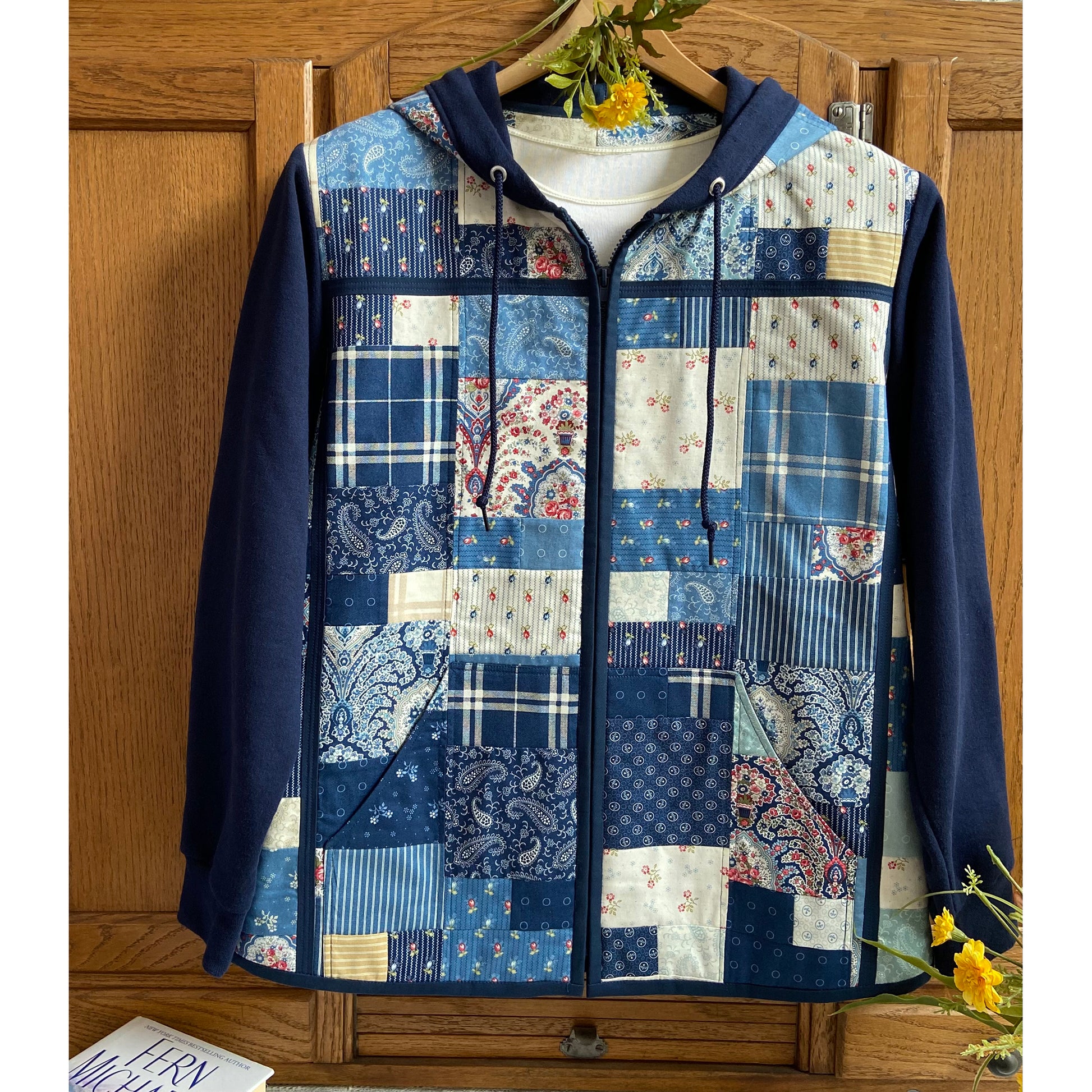 Beautiful quilted jacket in blues with patchwork looking front.