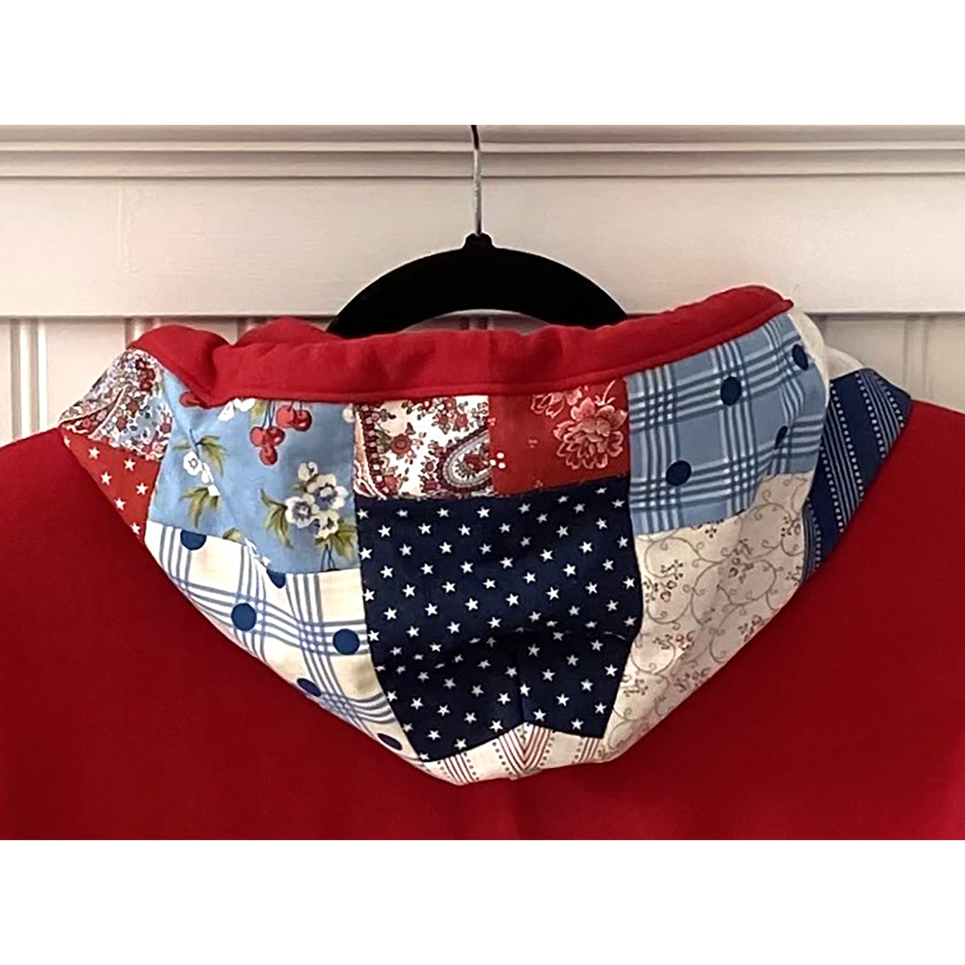 Showing the hoodie at the back of the sweatshirt with cute patchwork design to match the front (other photo). This one is a red sweatshirt with red, white and blue fabric.