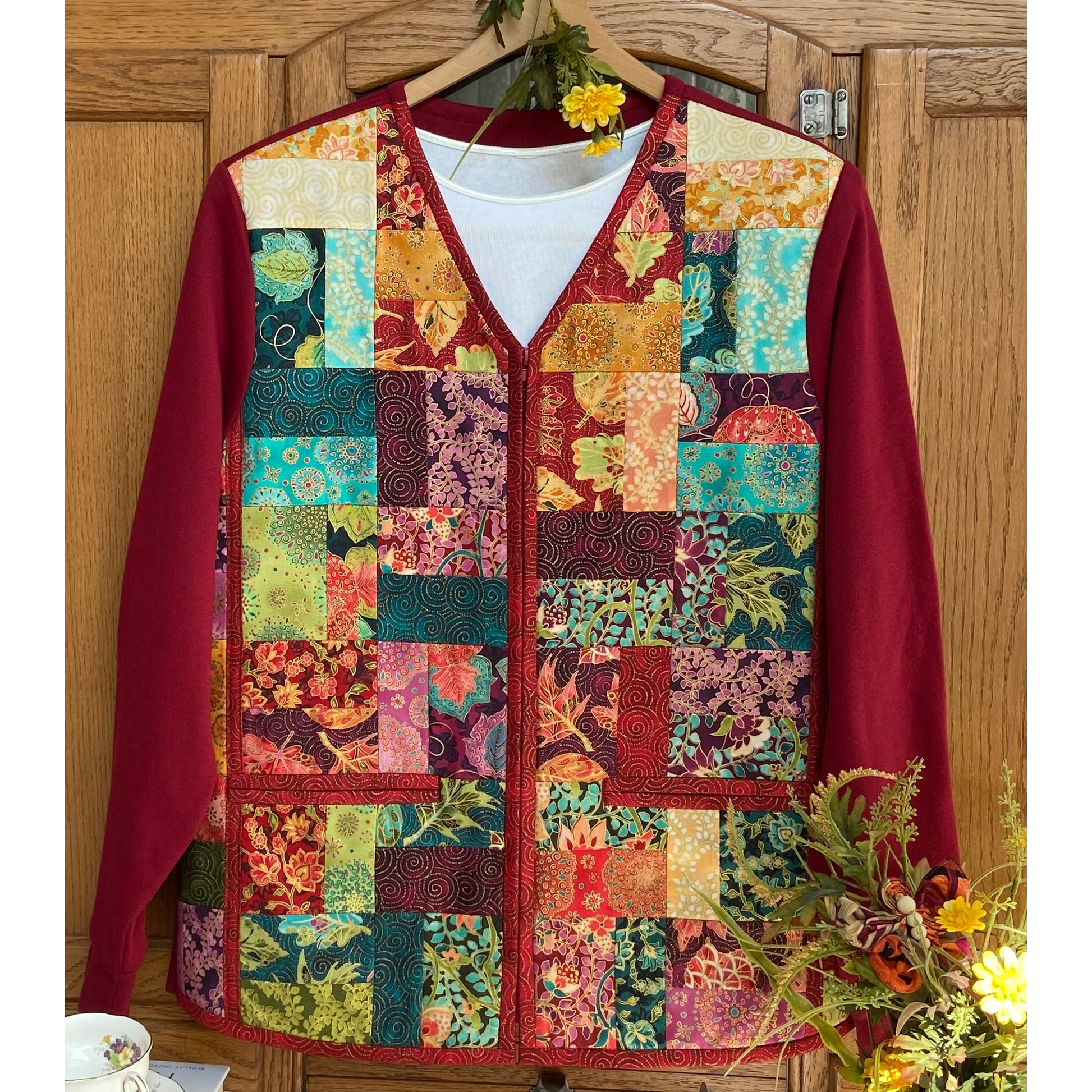 V-neck jacket with zipper and pockets. Adorable with patch work middle and solid colored sleeves. 