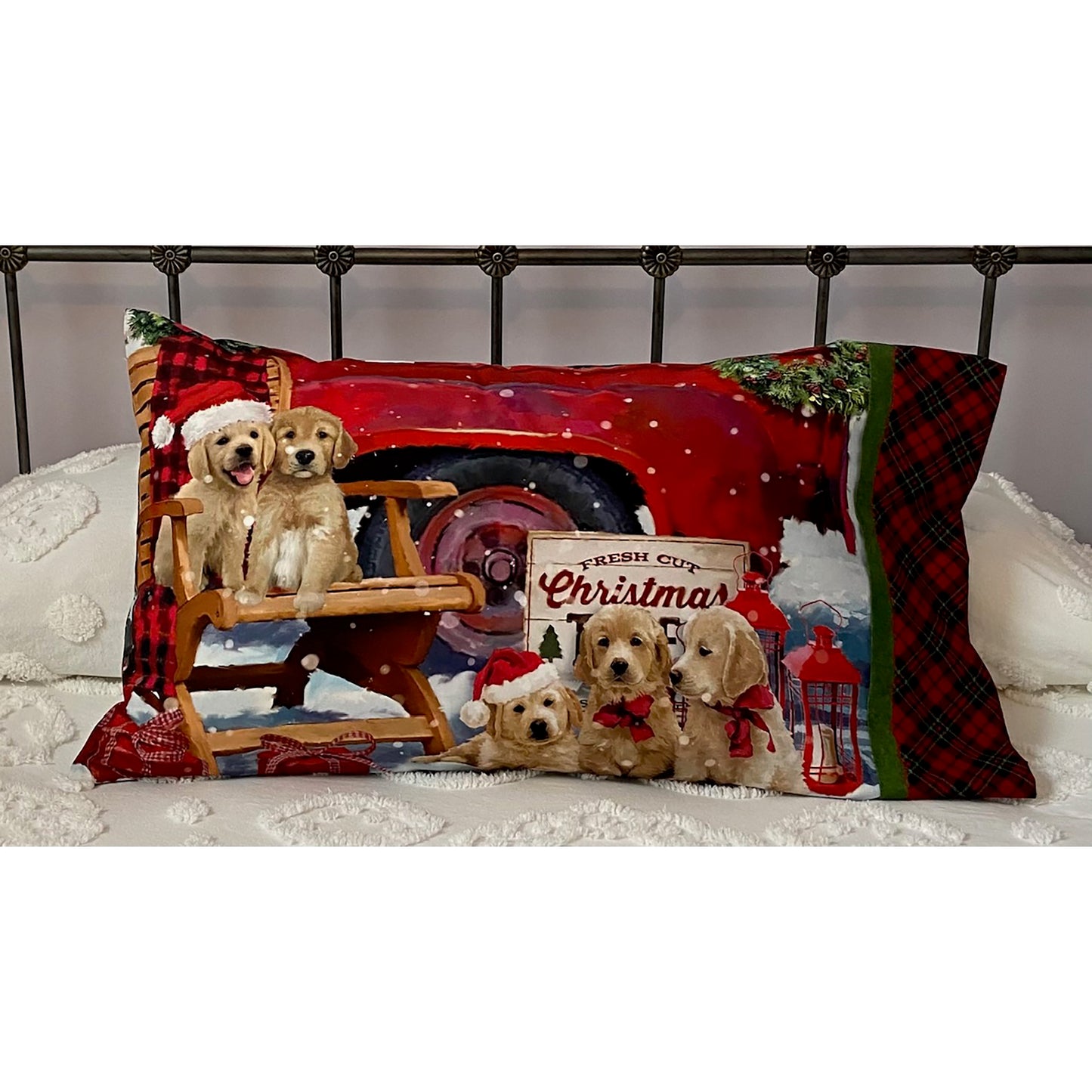 Pillowcase on a bed features some adorable puppies and part of a red truck.