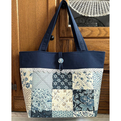 Adorable tote bag using a Charm Pack. It has a back zippered pocket to hold all your treasures. Fabrics in blues.