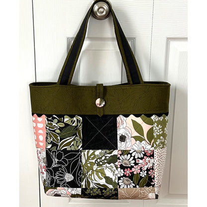 Adorable tote bag using a Charm Pack. It has a back zippered pocket to hold all your treasures. Floral fabrics shown in example with greens and some pink.