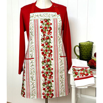 A one-of a kind apron using border stripe fabric. The apron is fully lined with pocket options. Make coordinating kitchen towels from leftover scraps.  Image shows the one in strawberries print.