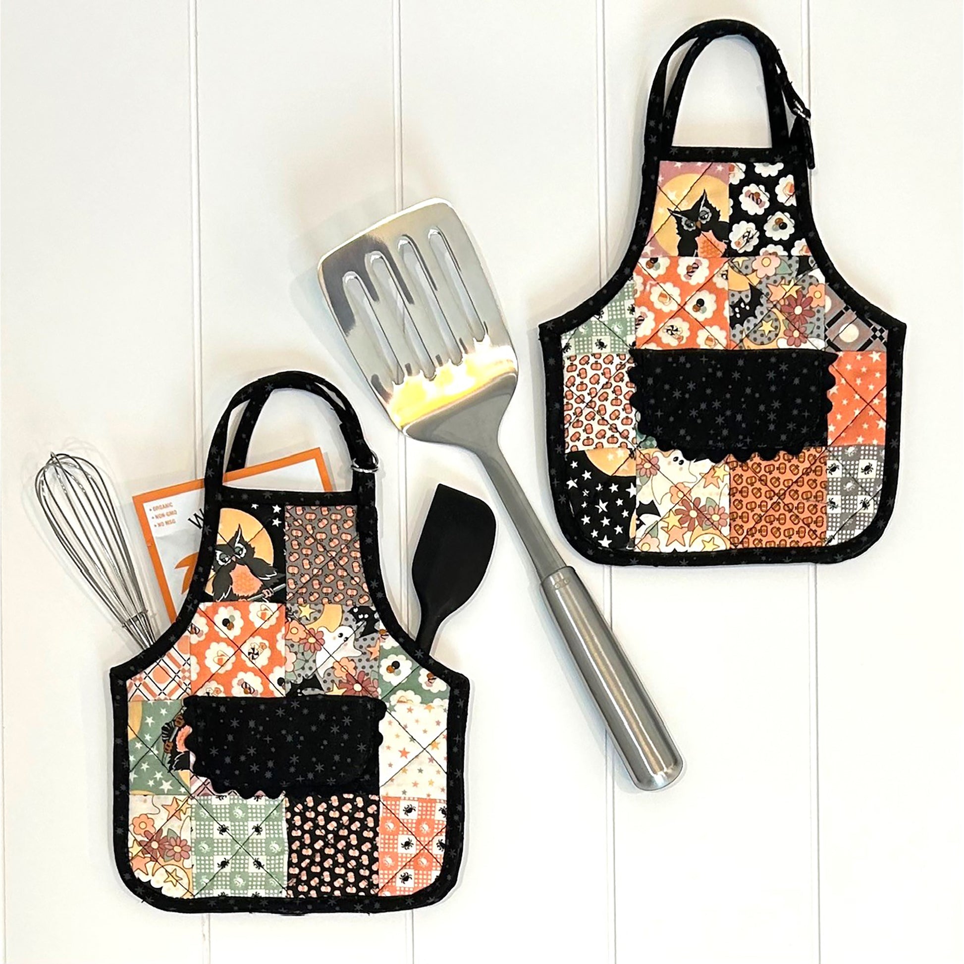 Cutest hot pads look like mini aprons!  Orange and black fabrics used in image shown.