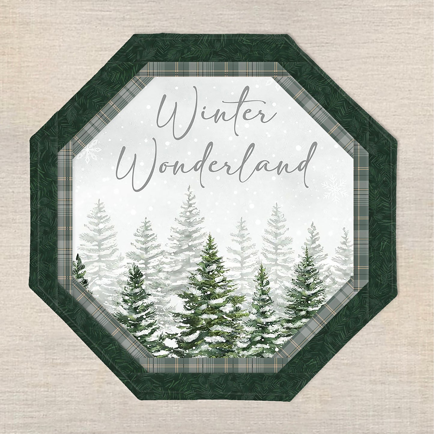 Octagon table topper features a print with pine tree tops covered in snow and the saying "Winter Wonderland".