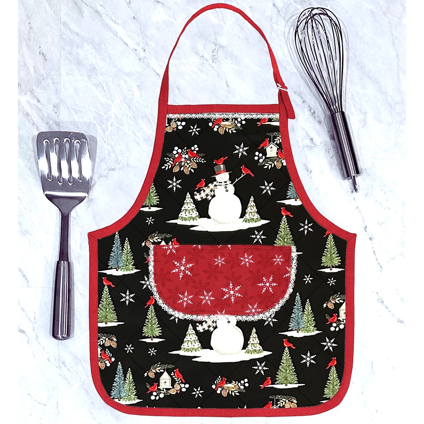 An adorable and festive apron shaped casserole hot pad featuring Christmas fabric with a snowman, pine trees and red cardinals.