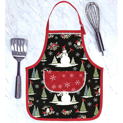 An adorable and festive apron shaped casserole hot pad featuring Christmas fabric with a snowman, pine trees and red cardinals.