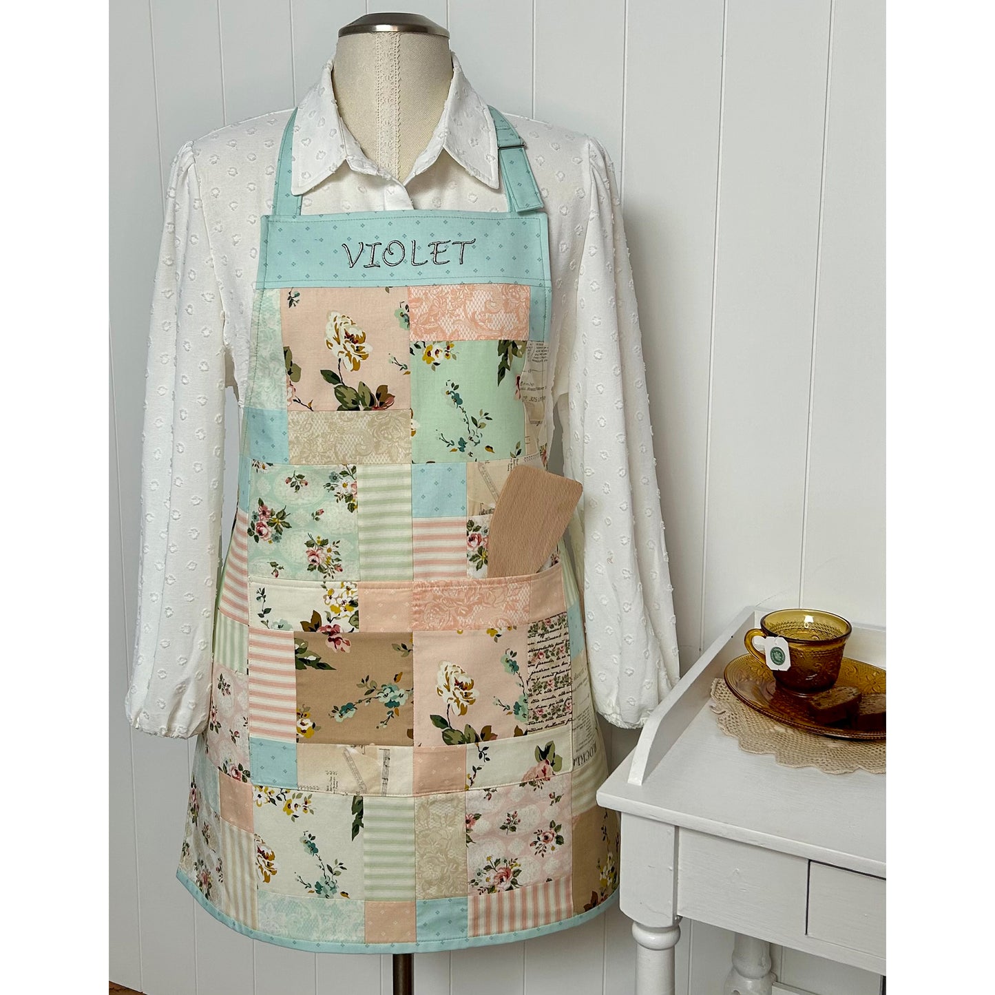 Fun charm pack apron showcasing light colored prints.