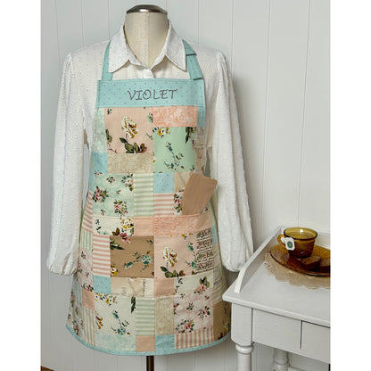 Fun charm pack apron showcasing light colored prints.