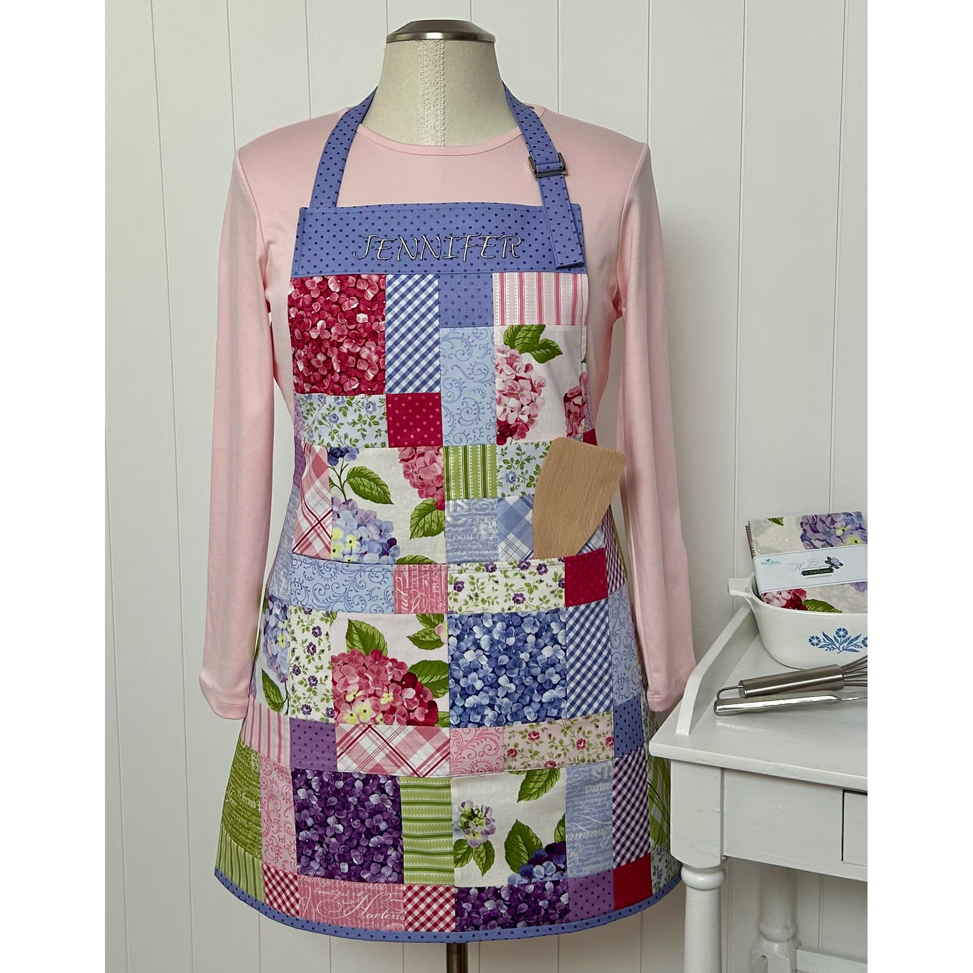 Fun charm pack apron showcasing floral prints.