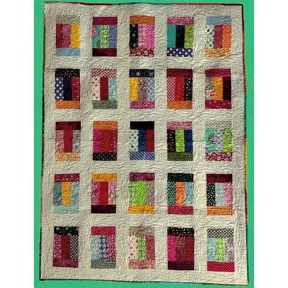 Fun quilt features lots of colorful fabric in rectangles with a cream background color.