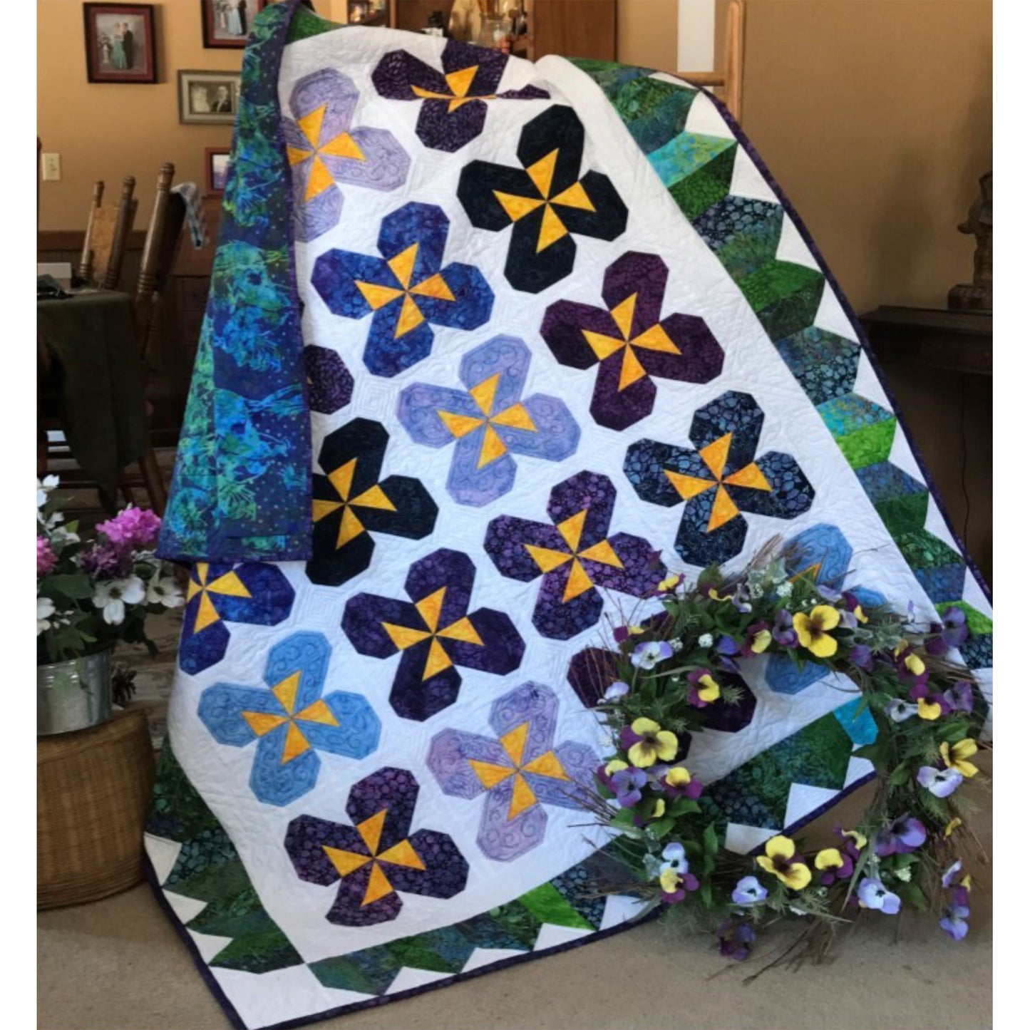 Pretty quilt features blocks of colorful pansies.