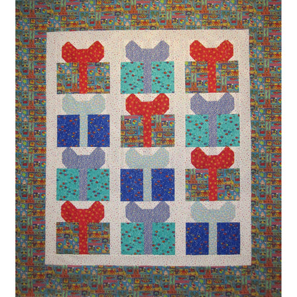 Adorable quilt features packages with bows in fun, bright colored fabric.